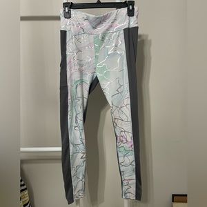 Grey/white leggings with colorful swirls and pockets